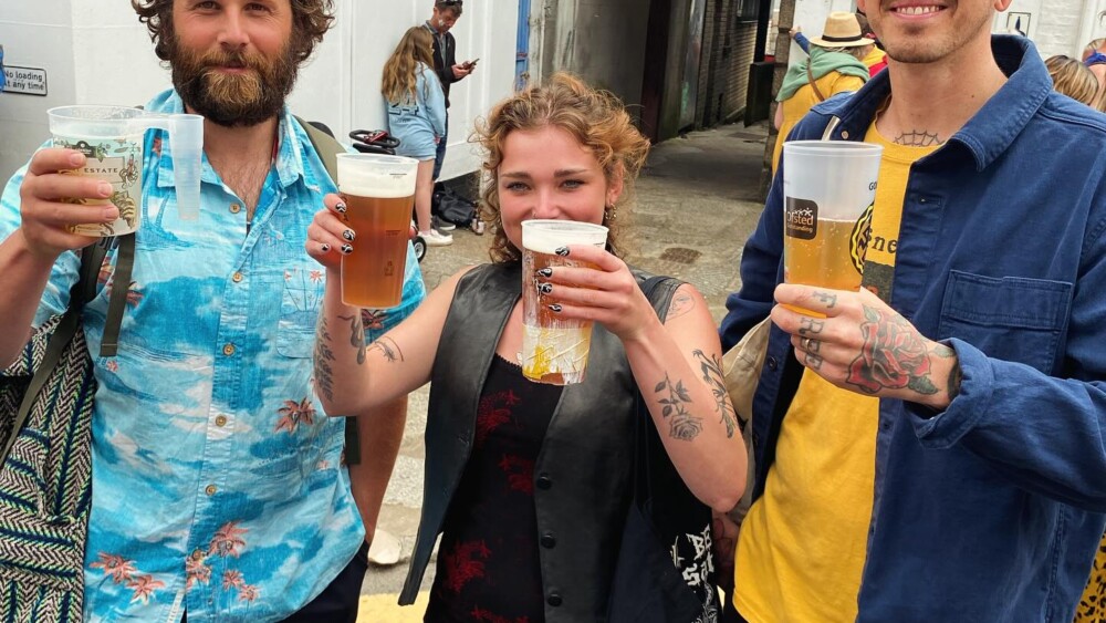 two men and a women with reuseable cups